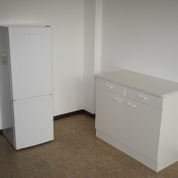 Dieses Zimmer ist mit Kühlschrank und Kommode sowie Stühlen eingerichtet. Die Betten ziehen mit den Bewohnerinnen und Bewohnern um.