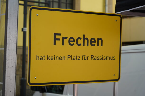Die Aufnahme zeigt das Schild "Frechen hat keinen Platz für Rassismus".